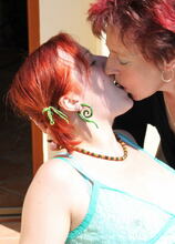 Horny housewife playing with a lesbian teen on the balcony