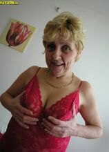 Horny blonde granny playing with a dildo